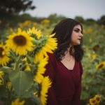 A woman poses with yellow sunflowers in Mississauga Ontario