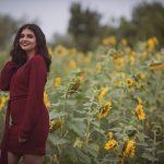 A woman poses with yellow sunflowers in Mississauga Ontario