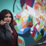 A woman poses beside a public art installation in Mississauga Ontario